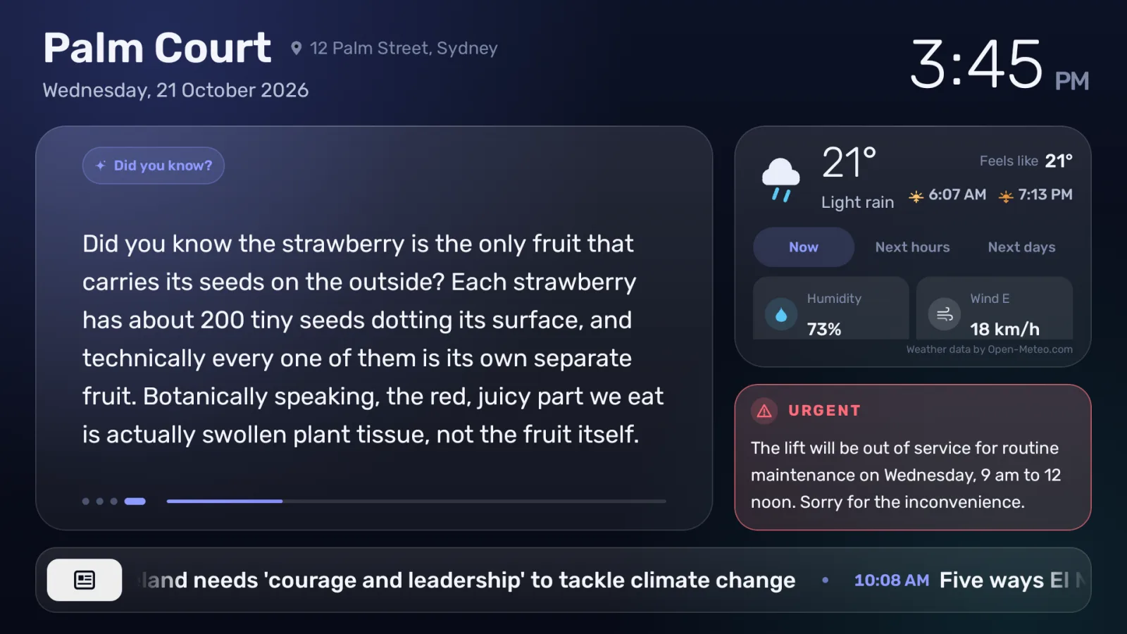 The building’s screen showing a “Did you know?” item about strawberries beside the weather, an urgent notice and news headlines